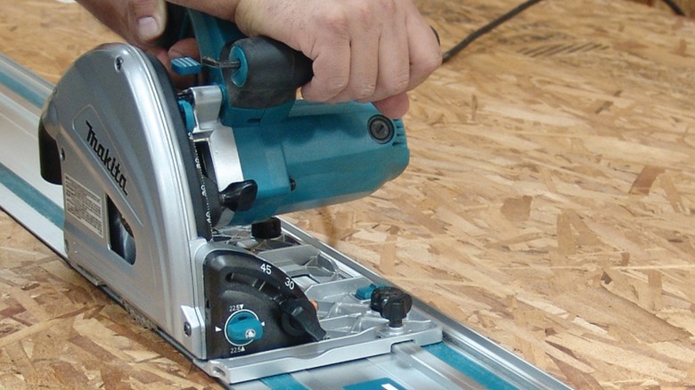 Person using Makita track saw