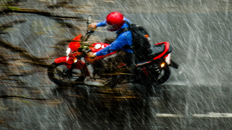 A motorcycle rider in the rain.