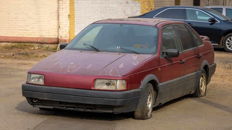 Broken down old car with flat tires