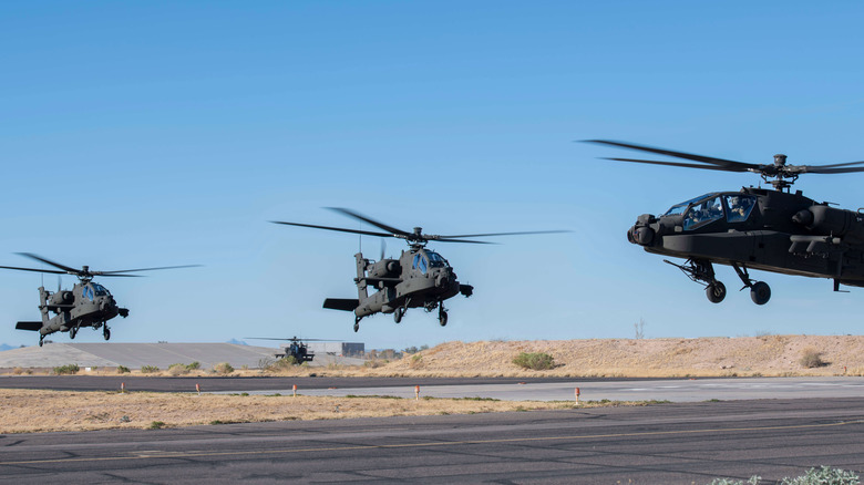 AH-64 Apaches landing on a runway