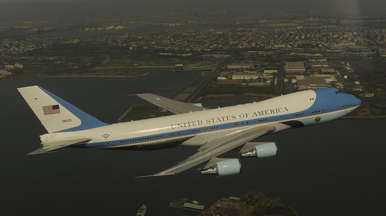 Air Force one flying over statue of liberty