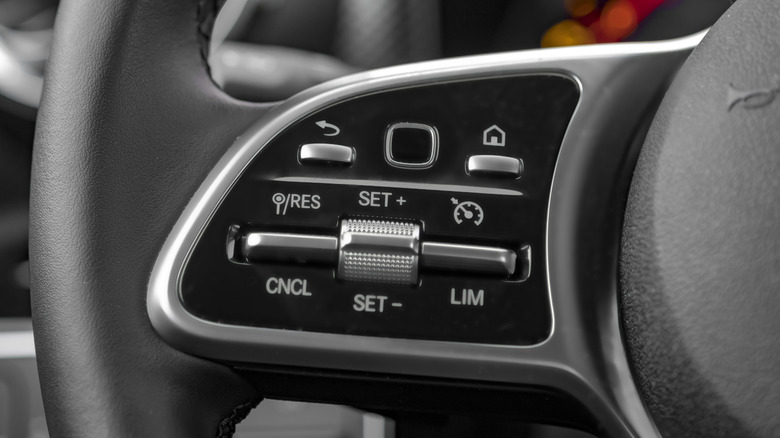 The buttons and dials on a steering wheel that operate cruise control.