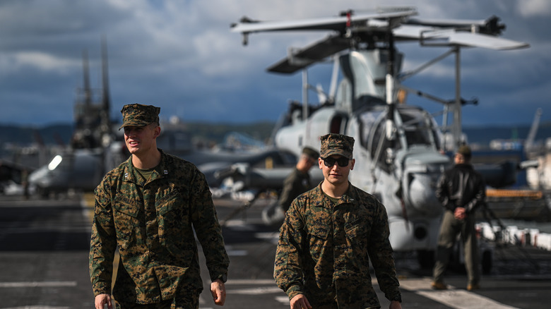 Two marines smiling on deck of an amphibious assault ship