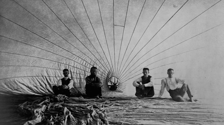 men inside an observation balloon