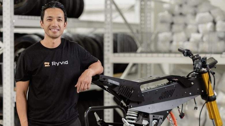 Ryvid CEO Dong Tran near in-production chassis of Anthem electric motorcycle