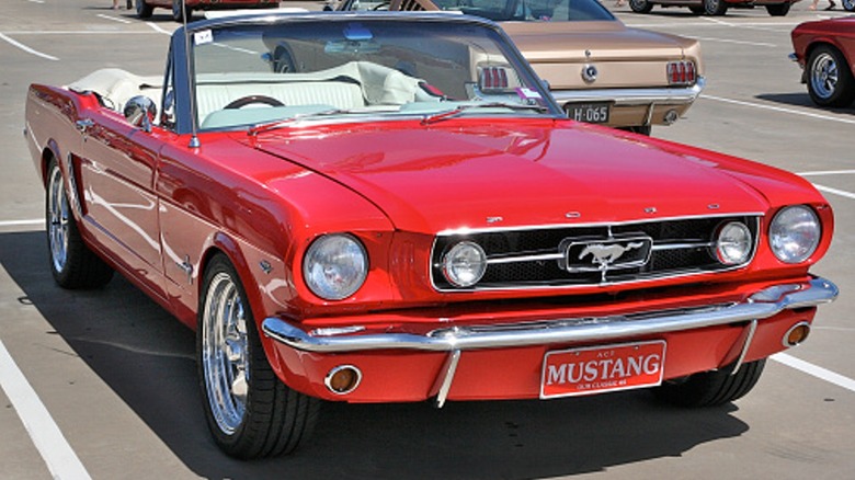 Red 1965 Mustang Convertible in parking lot