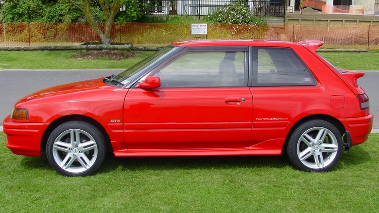 Parked red Mazda 323 GTX