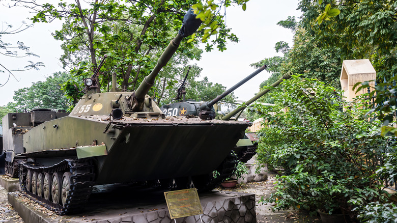 PT-76 tank on display in wooded area