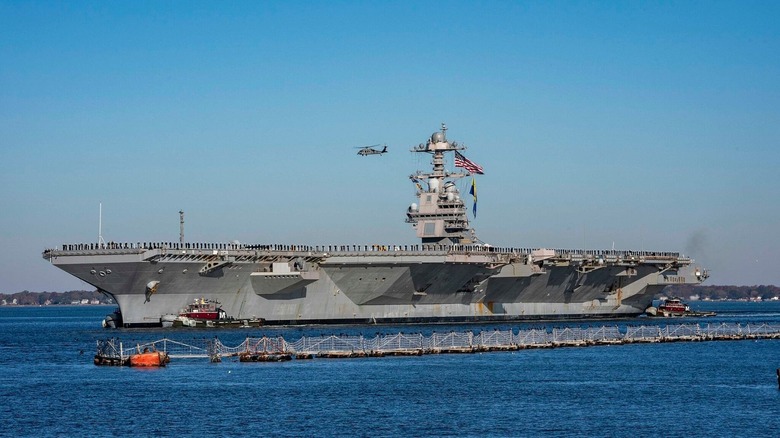 USS Gerald R. Ford with helicopter flying overhead