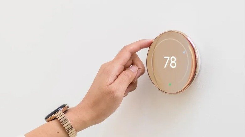 Person interacting with Nest Learning Thermostat