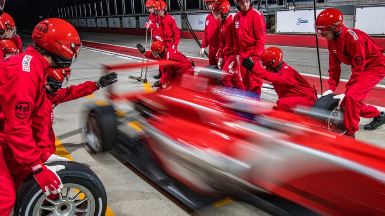 Race car zips past pit stop