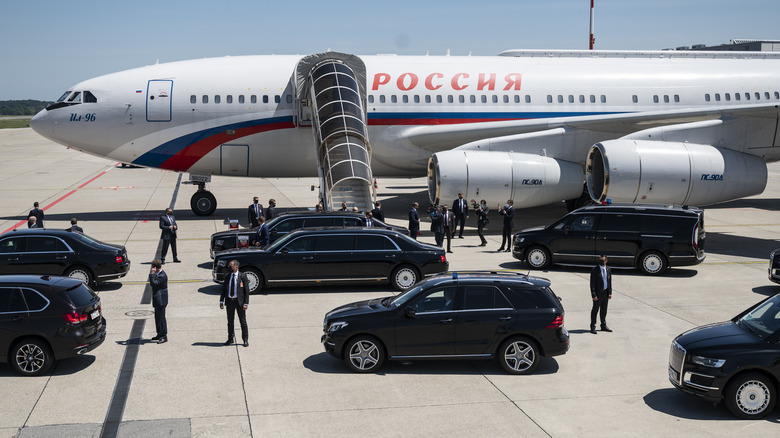 Il-96-300PU surrounded by security staff.