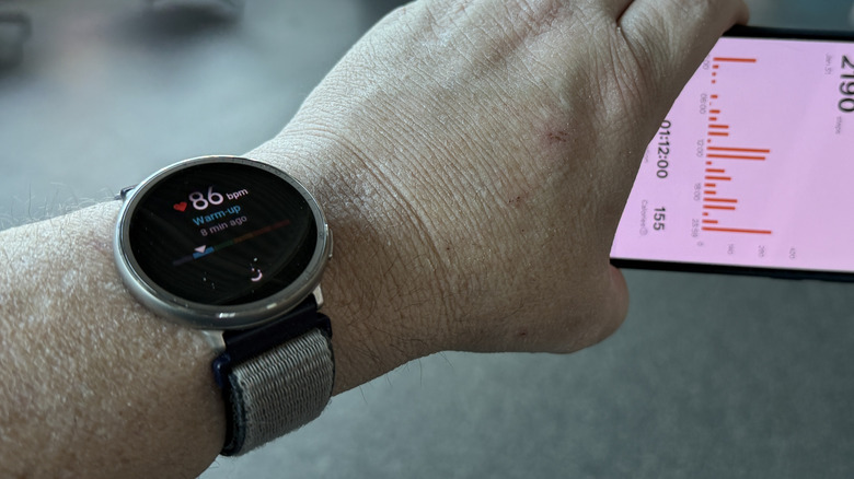 Man holding a phone wearing a watch