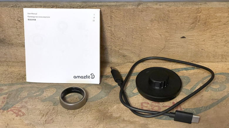 Amazfit Helio Ring box contents, including the ring, charger, cable, and instructions.