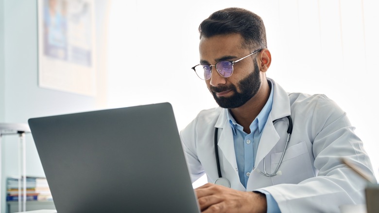 Doctor looking at laptop