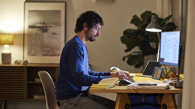 man working with warm lighting