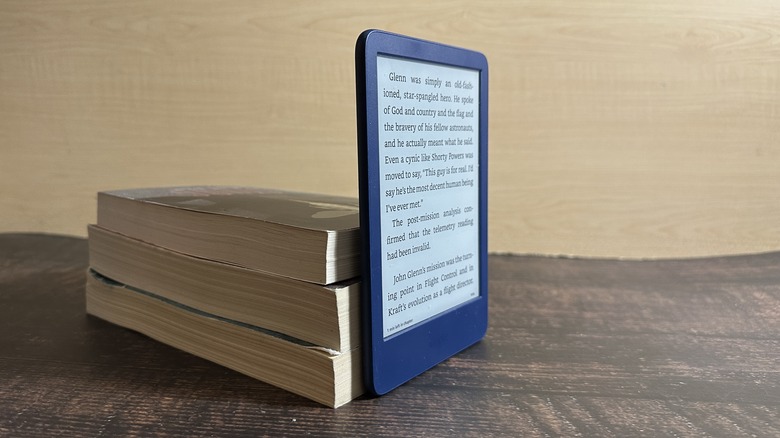 Kindle leaning on a stack of books