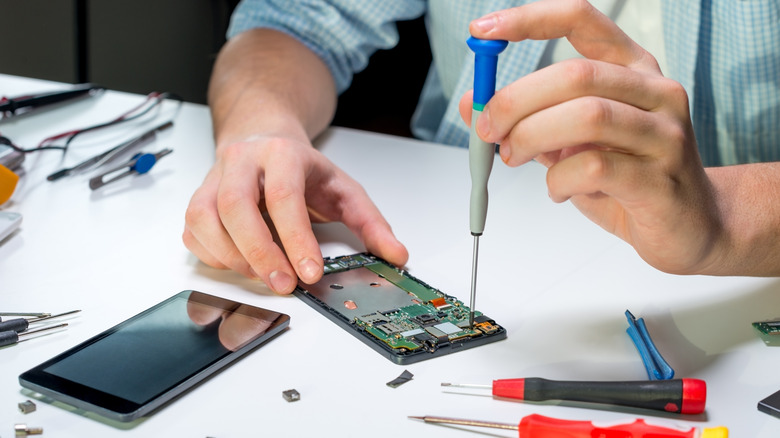 Technician repairing smartphone