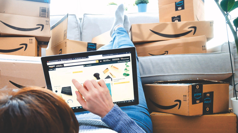 Person surrounded by Amazon boxes