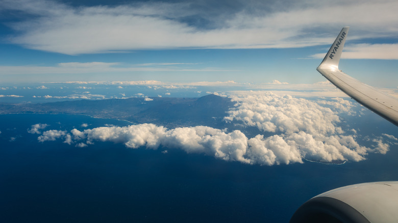 A volcanic mountain seen from the window of an airplane