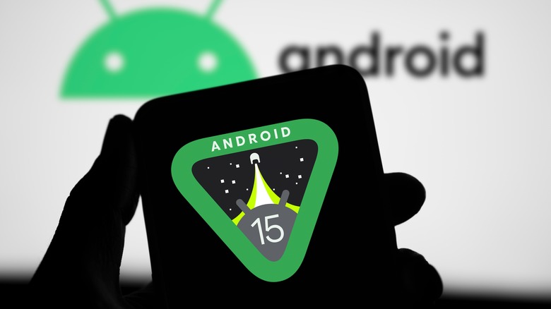Silhouette of phone displaying Android 15 logo