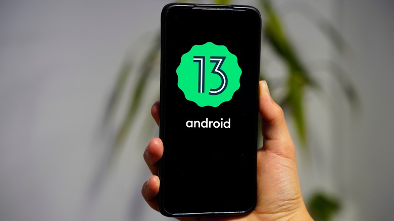 Android 13 logo on a smartphone.