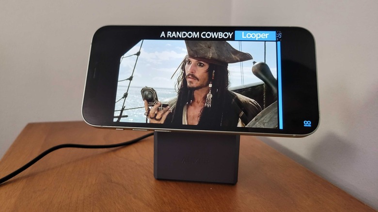 Youtube playing on a phone charging on Anker's cube