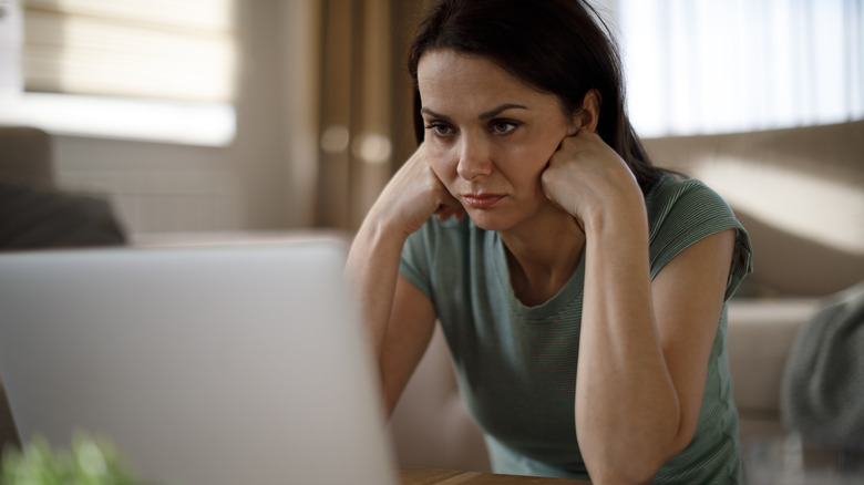 woman frustrated looking at laptop