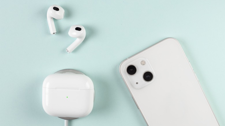 AirPods charging next to iPhone