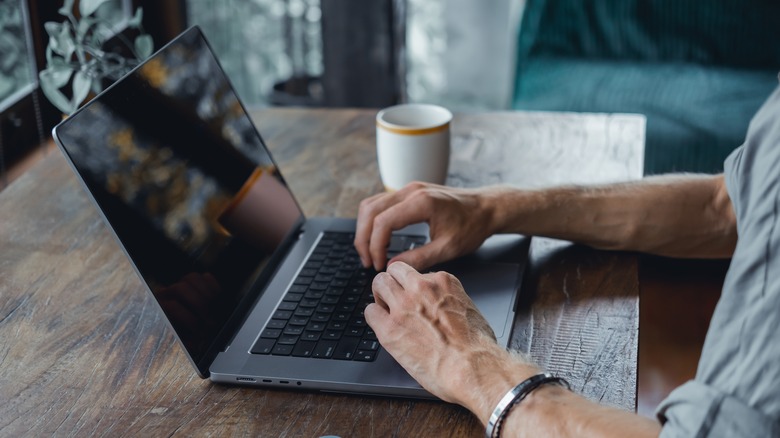 Person typing on MacBook