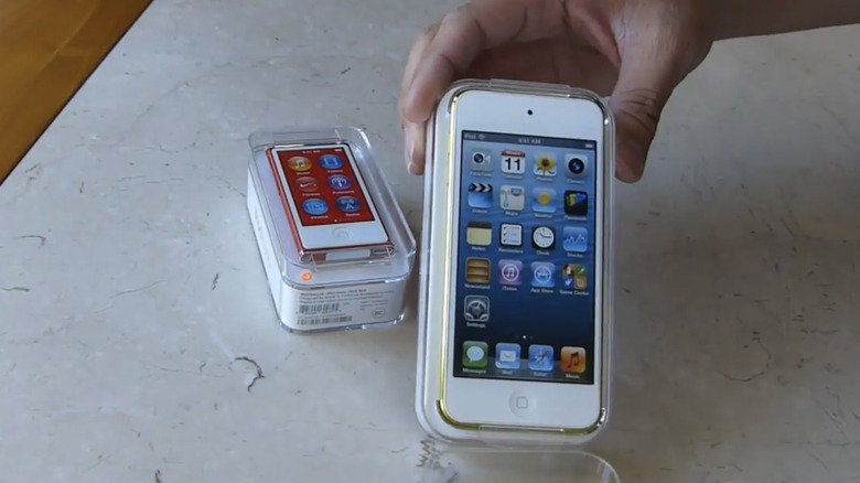 A person unboxing the iPod Touch.