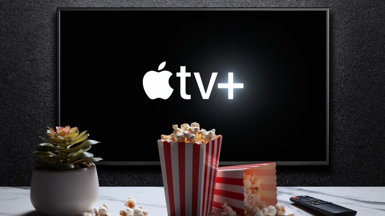 Apple TV+ logo on a television and popcorn on a table