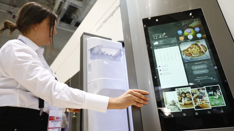 woman opening smart fridge