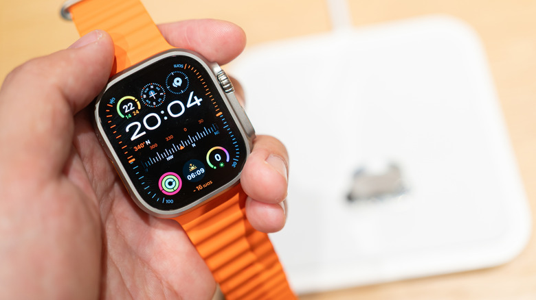 person holding Apple Watch Ultra 2