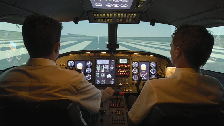 Two pilots sitting in an aircraft cockpit.