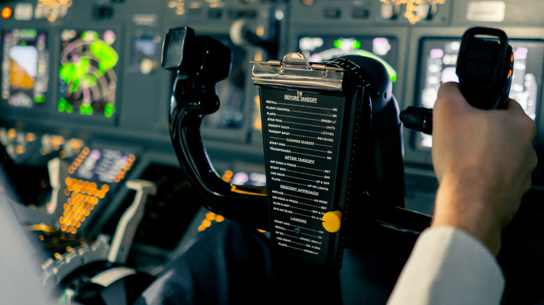 A pilot holding onto an aircraft's flight controls.