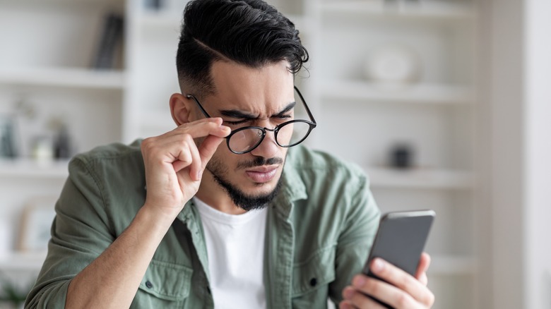 Person looking at phone screen.