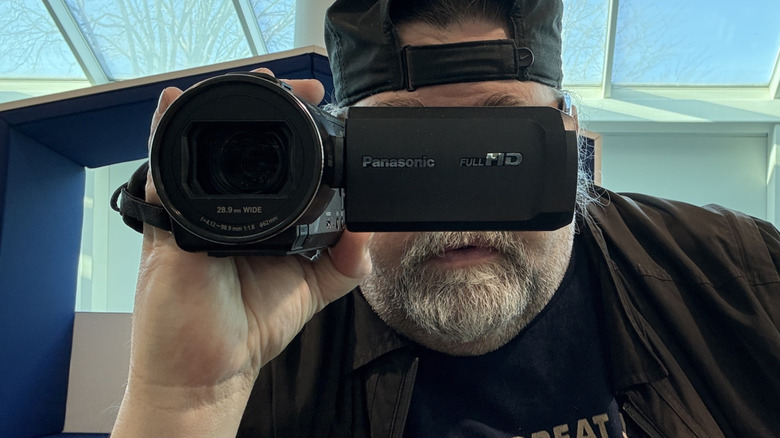 A man holds a camcorder