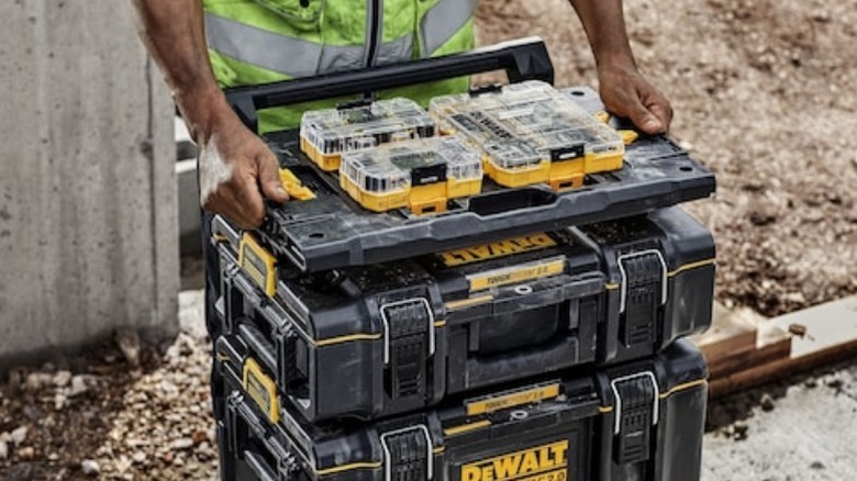 Person using DeWalt adapter tray on workstation