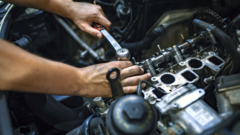 Mechanic working on car engine