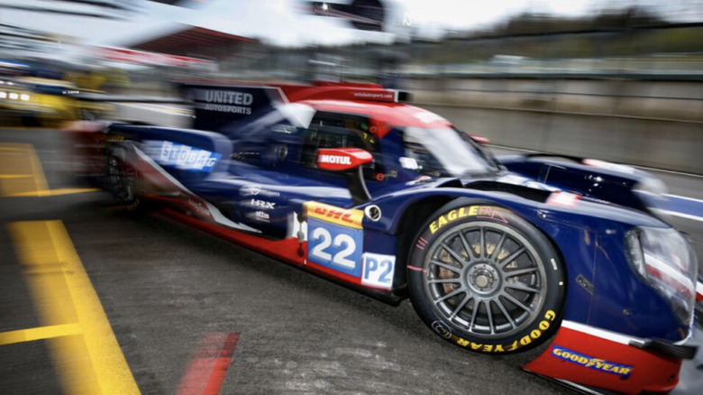 Blue race-car with red trim using goodyear tires