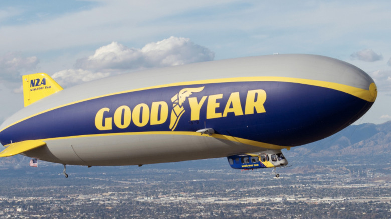 The Goodyear blimp flying over a city