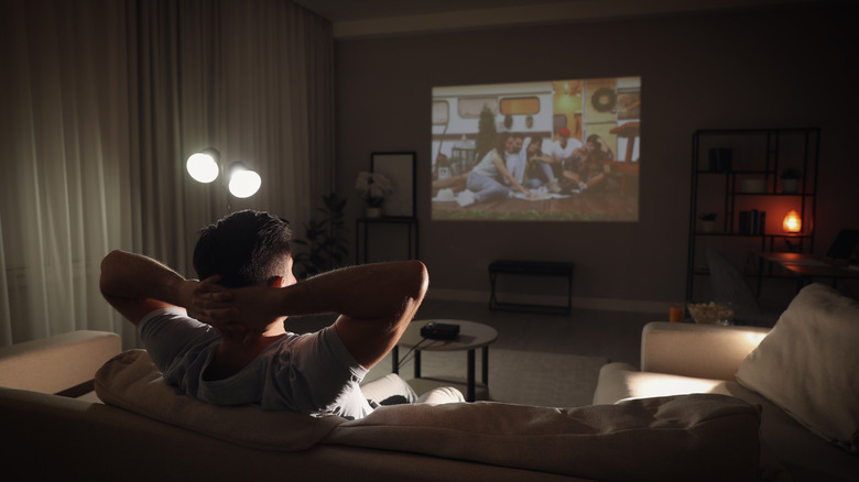 Man watching movie on projector