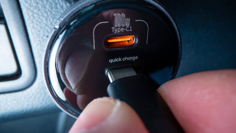 plugging in USB type C cable into a car charger