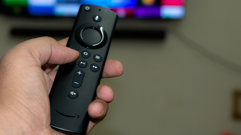 Person holding Amazon Fire TV remote