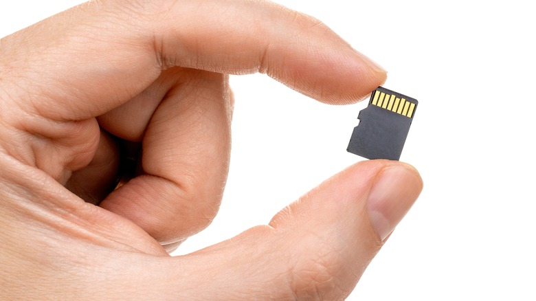 two fingers holding microSD card