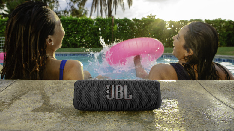 JBL Flip 6 by a pool with two women