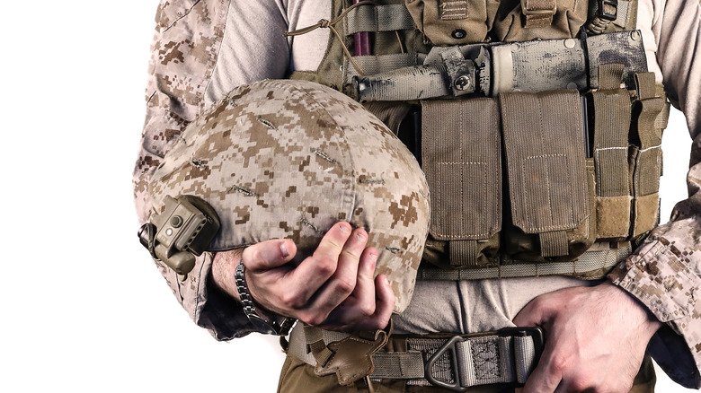 Soldier holding ballistic helmet