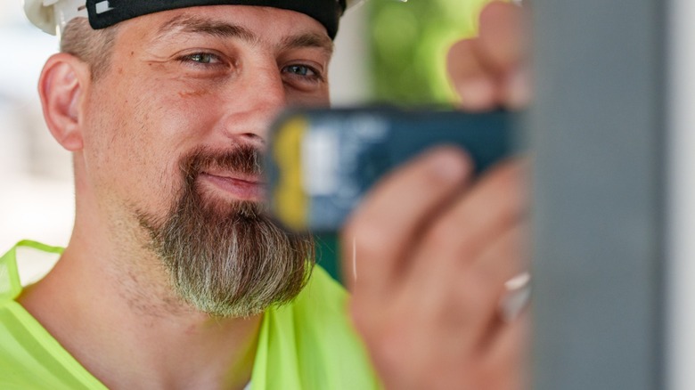 person using laser tool