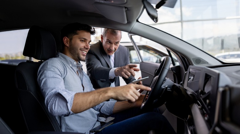 person learning car functions at dealership